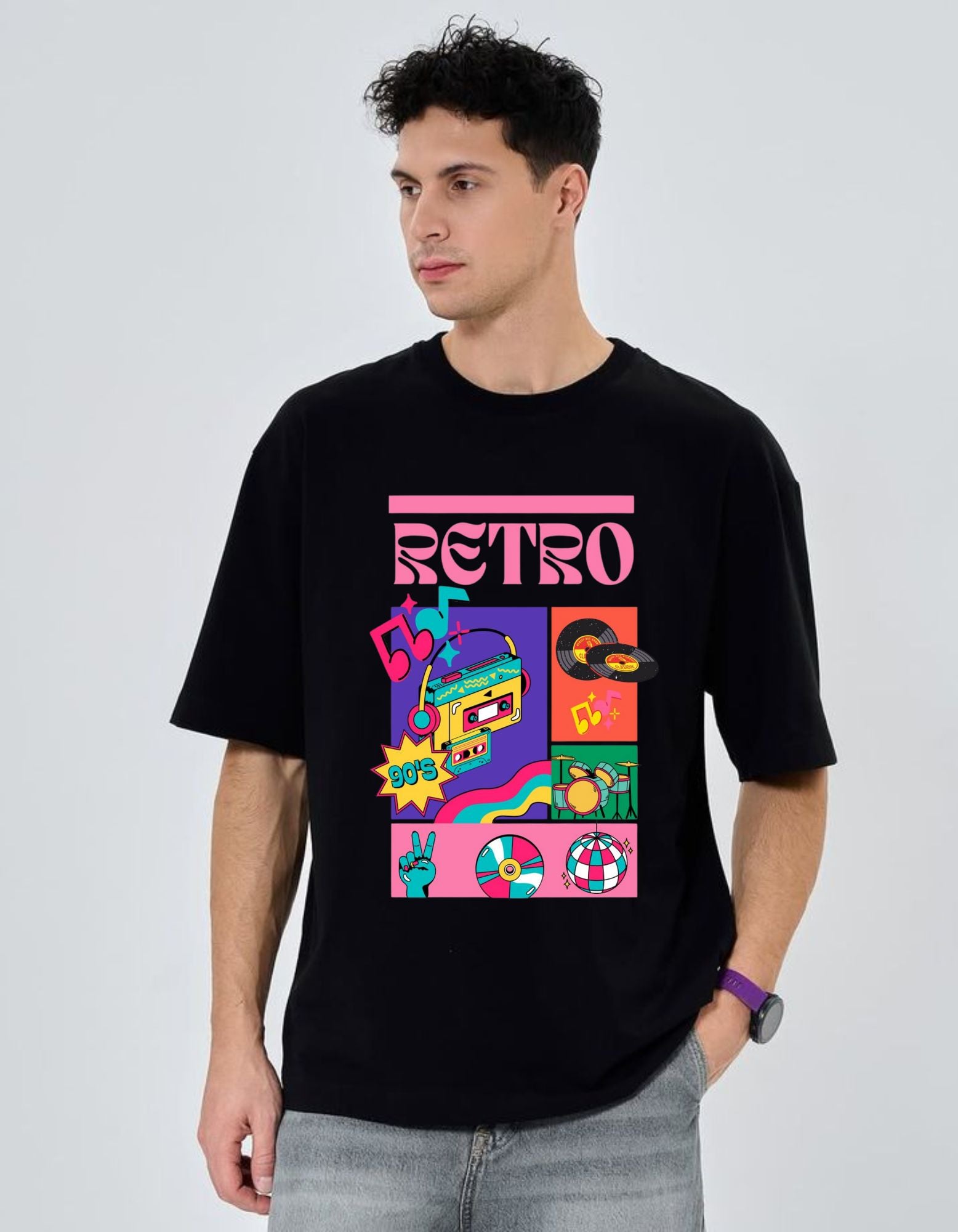 Person wearing a black t-shirt with a colorful 'Retro' design on a light gray background